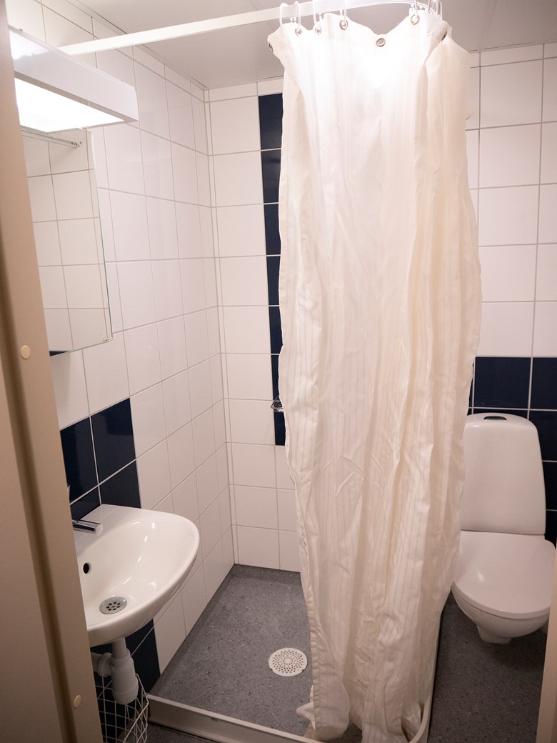 Badrum, Gråbo internat, Dalslands folkhögskola i Färgelanda. Handfat med spegel, dusch med draperi och toastol.