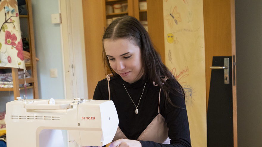 En deltagare som syr på symaskin