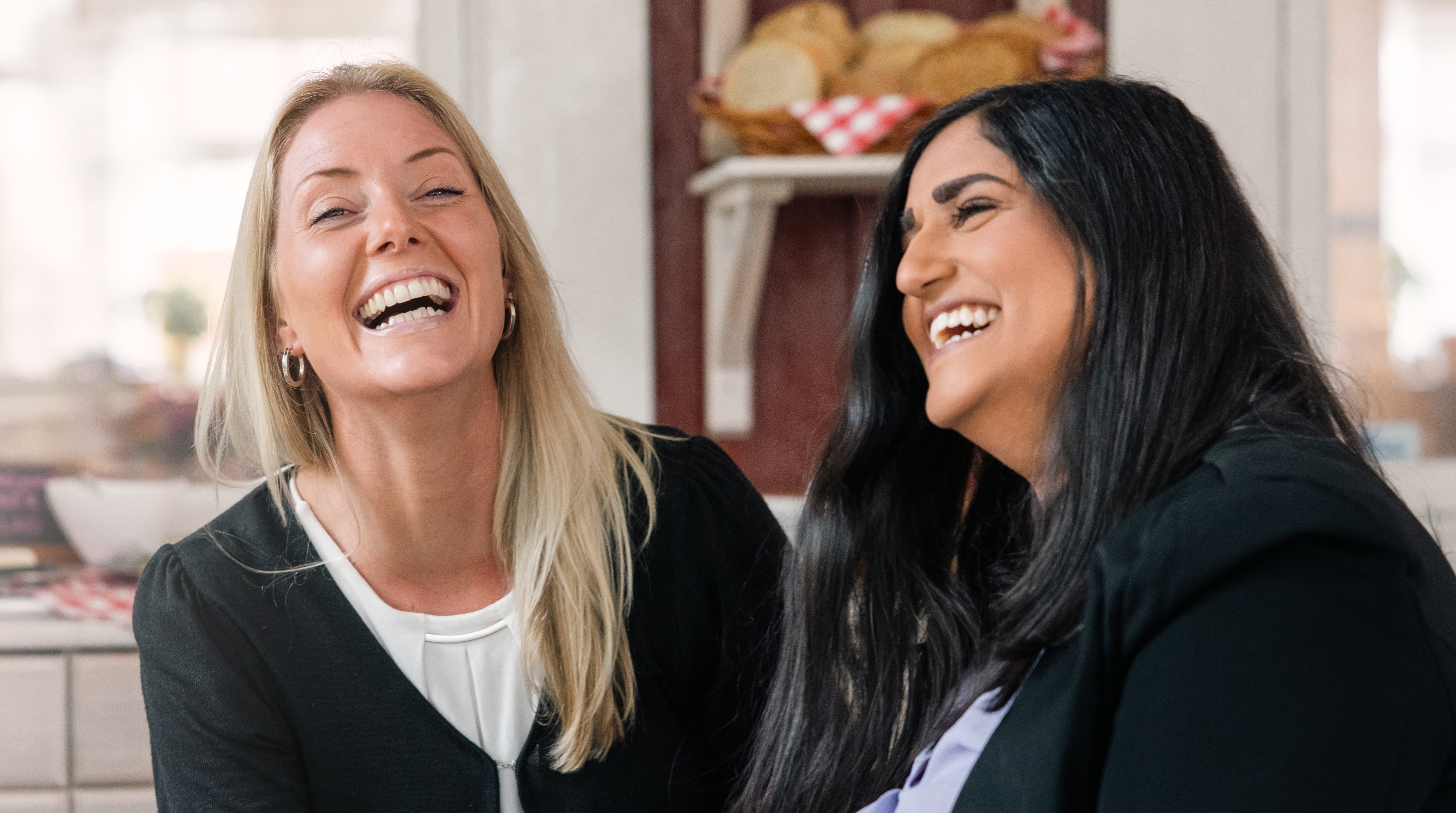 Två folkhögskoledeltagare som skrattar.